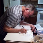 Artist, R. D. Burton, at work on new drawing