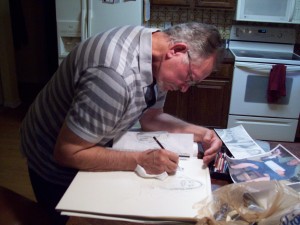 Artist, R. D. Burton, at work on new drawing