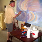 Artist, Richard Burton painting in his garage.